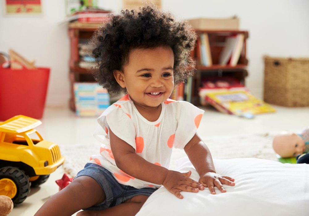 happy-baby-girl-playing-with-toys-playroom